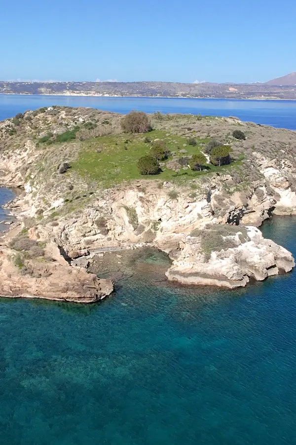 Charming coastal view of Karga island, featuring traditional village architecture and turquoise Mediterranean waters.